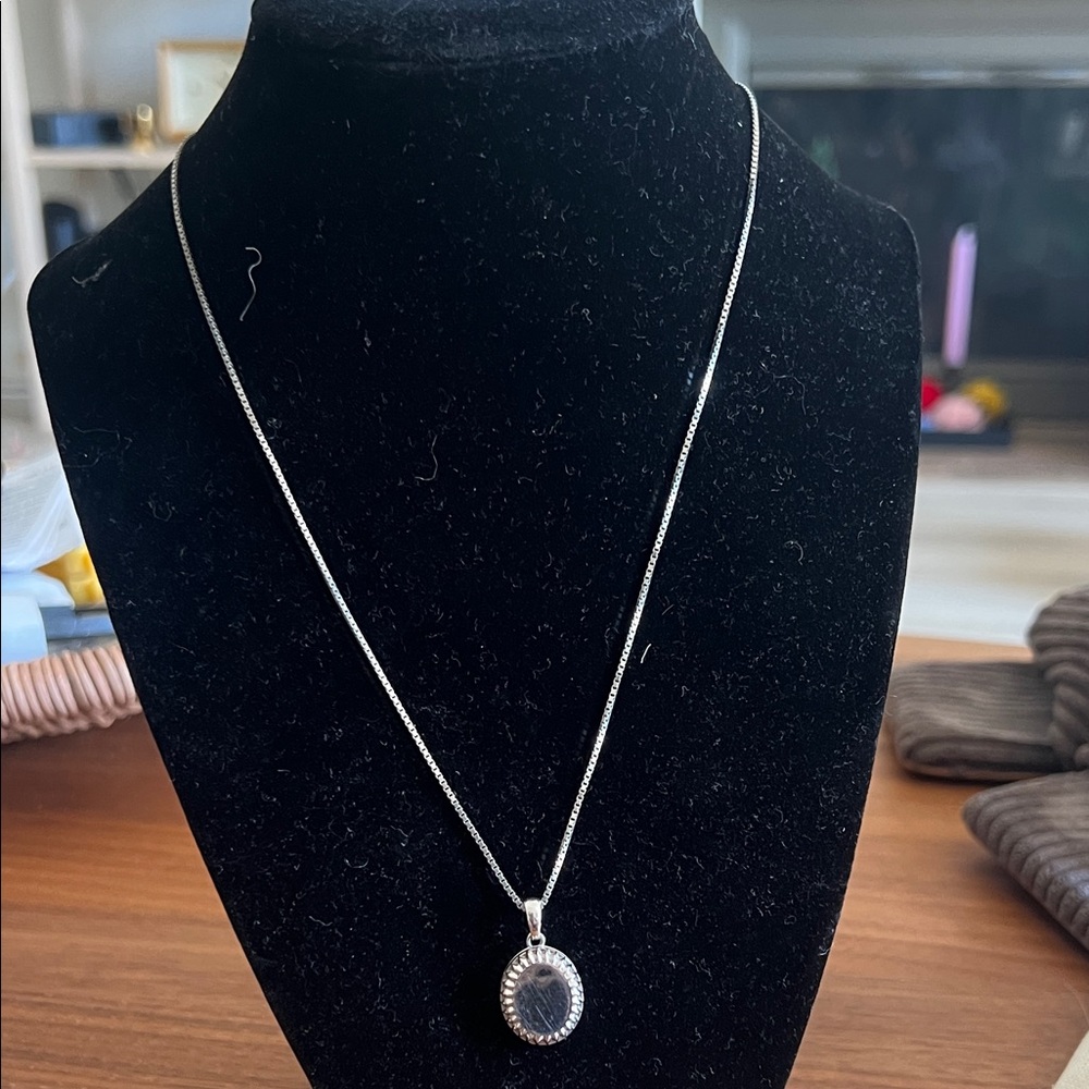 Their Sutton Oval locket in sterling Silver
